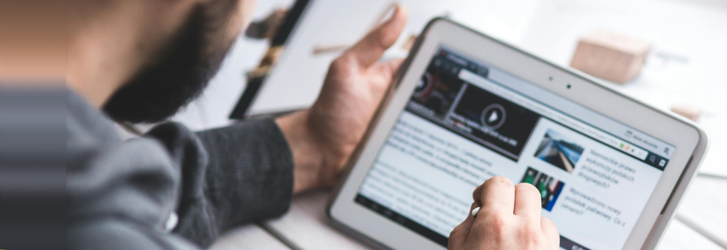 A person reading the news on a tablet