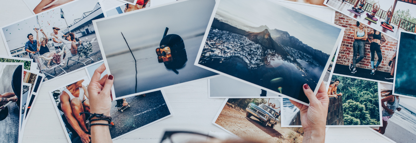 Person looking at a variety of photographs