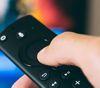 Hand holding a TV remote